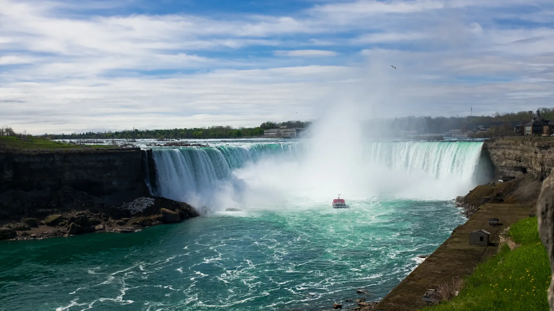 Golden-hour light on the Horseshoe Falls with mist rising over the Canadian side of Niagara